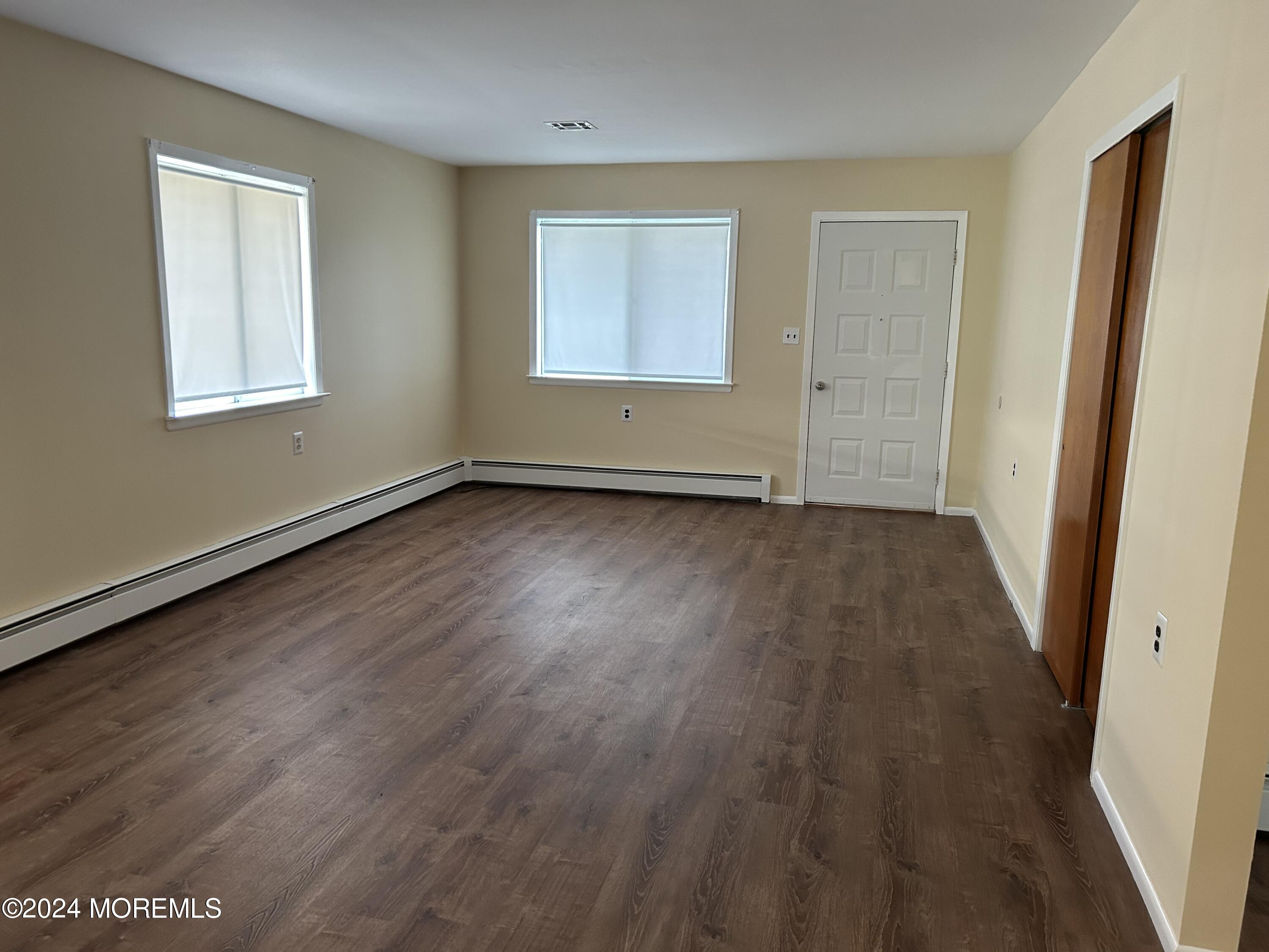 38 Eldorado Street Toms River, NJ 08757 - Photo 6 of 11 a view of an empty room with wooden floor and a window