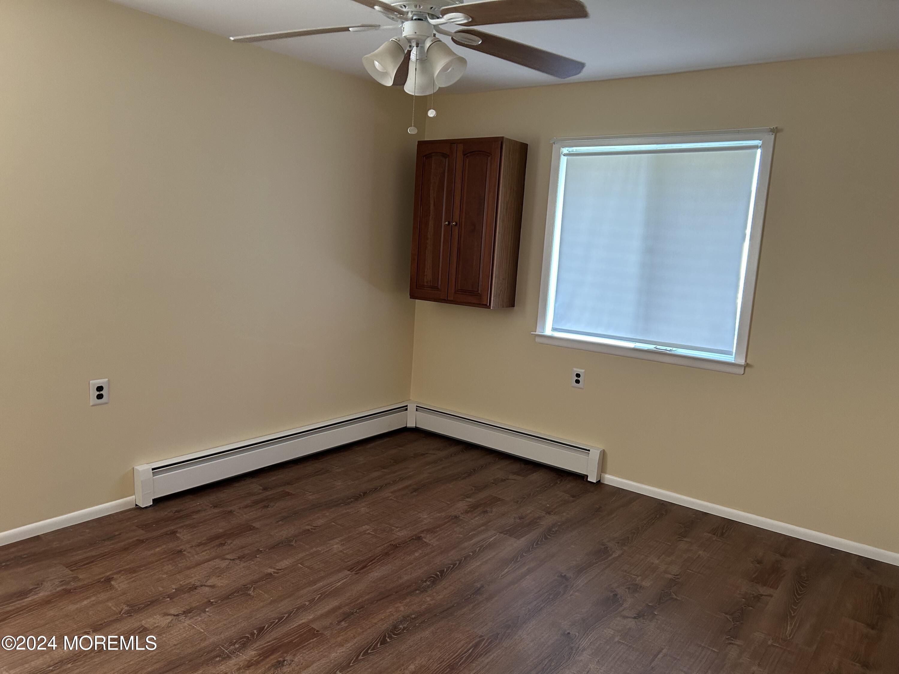 38 Eldorado Street Toms River, NJ 08757 - Photo 9 of 11 a view of an empty room with wooden floor and a window