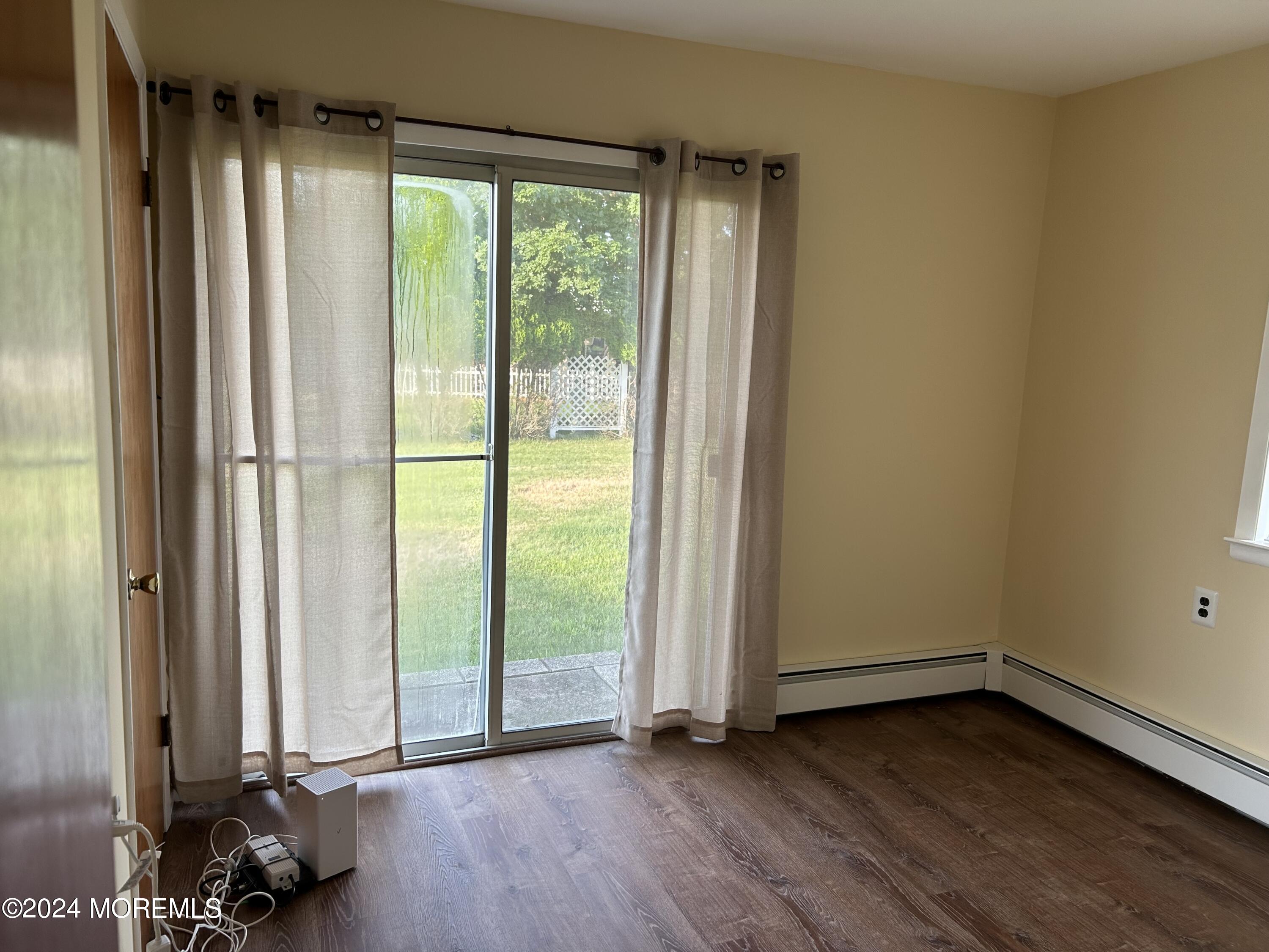 38 Eldorado Street Toms River, NJ 08757 - Photo 10 of 11 an empty room with wooden floor and windows