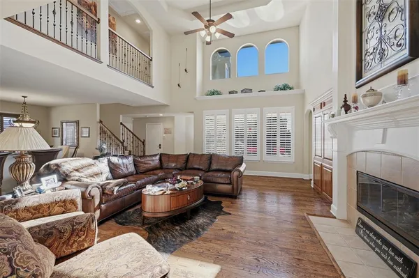 a living room with furniture a fireplace and a chandelier