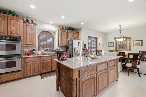 a kitchen with sink stove and cabinets