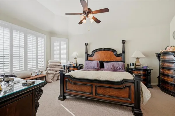 a bedroom with a bed bed and a chandelier
