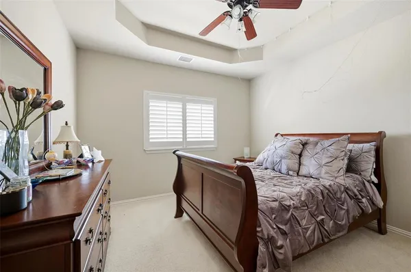 a bed room with a bed window and a chair