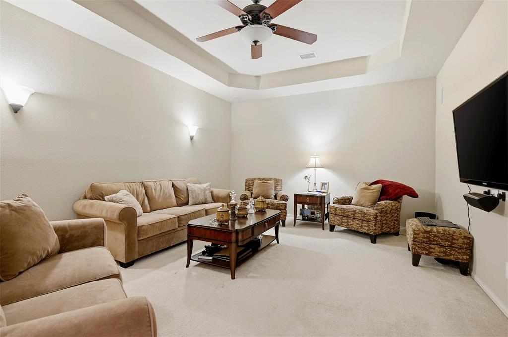 14875 Daneway Drive Frisco, TX 75035 - Photo 26 of 34 a living room with furniture and a flat screen tv