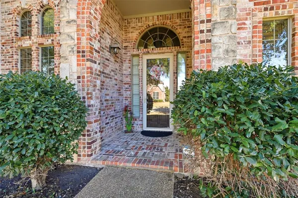 a view of a brick building next to a yard