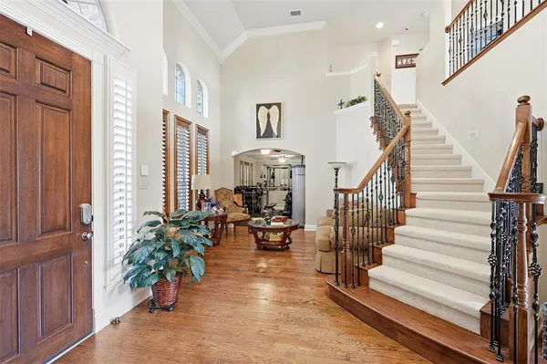 a view of entryway and hall with wooden floor