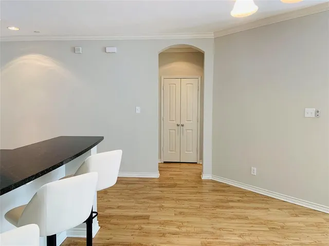 an empty room with wooden floor and a window