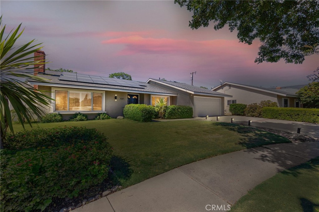 a front view of a house with a garden