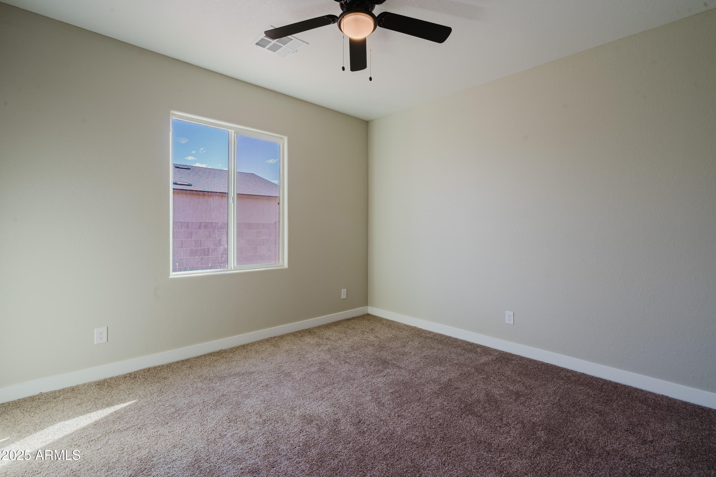 14951 South Capistrano Road Arizona City, AZ 85123 - Photo 11 of 27 an empty room with a window and a fan