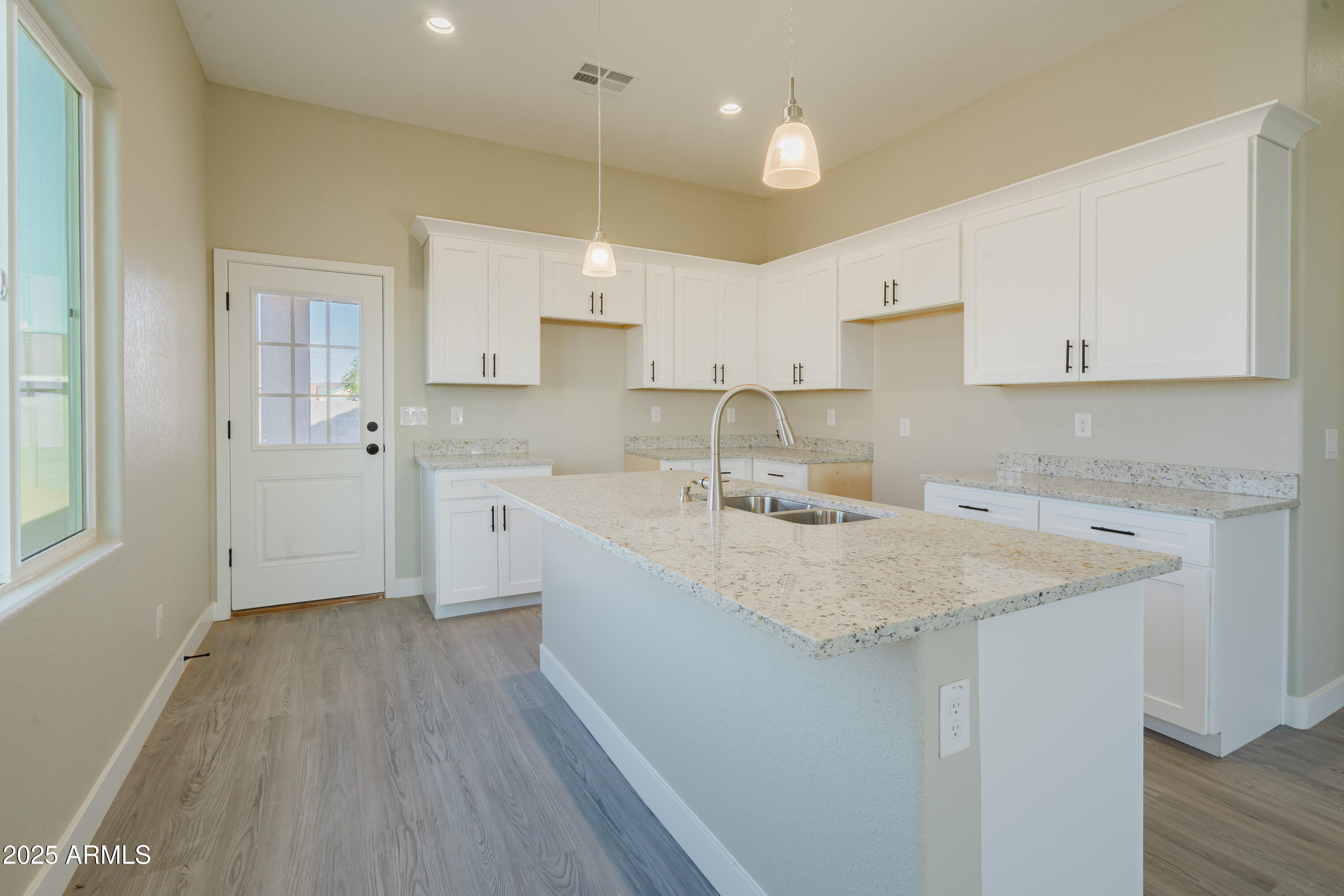 14951 South Capistrano Road Arizona City, AZ 85123 - Photo 4 of 27 a kitchen with a sink a stove a refrigerator and white cabinets