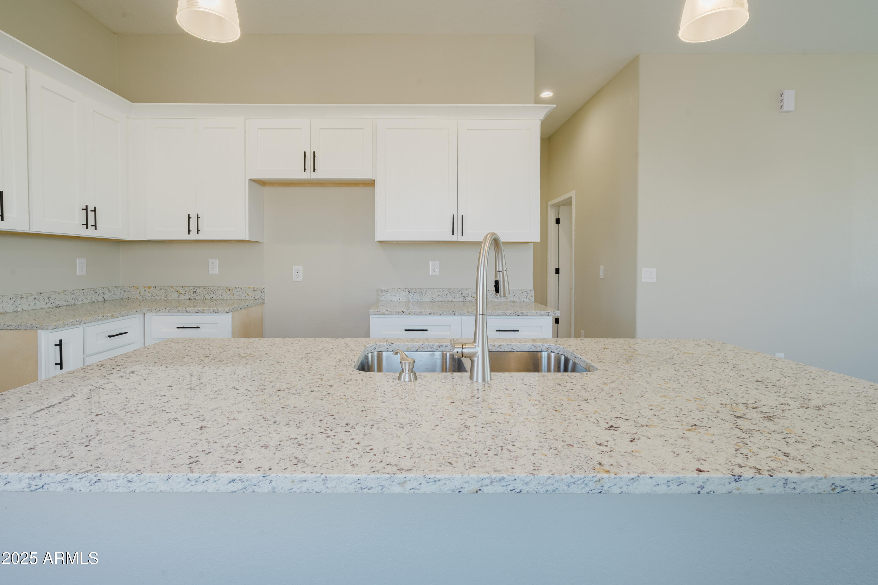 14951 South Capistrano Road Arizona City, AZ 85123 - Photo 6 of 27 a kitchen with white cabinets and sink