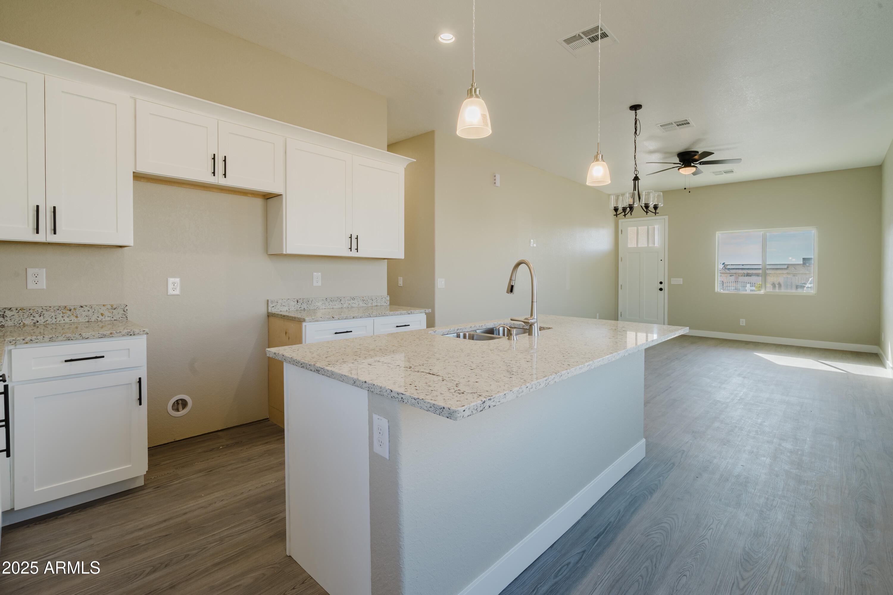 14951 South Capistrano Road Arizona City, AZ 85123 - Photo 7 of 27 a kitchen with a sink cabinets and wooden floor