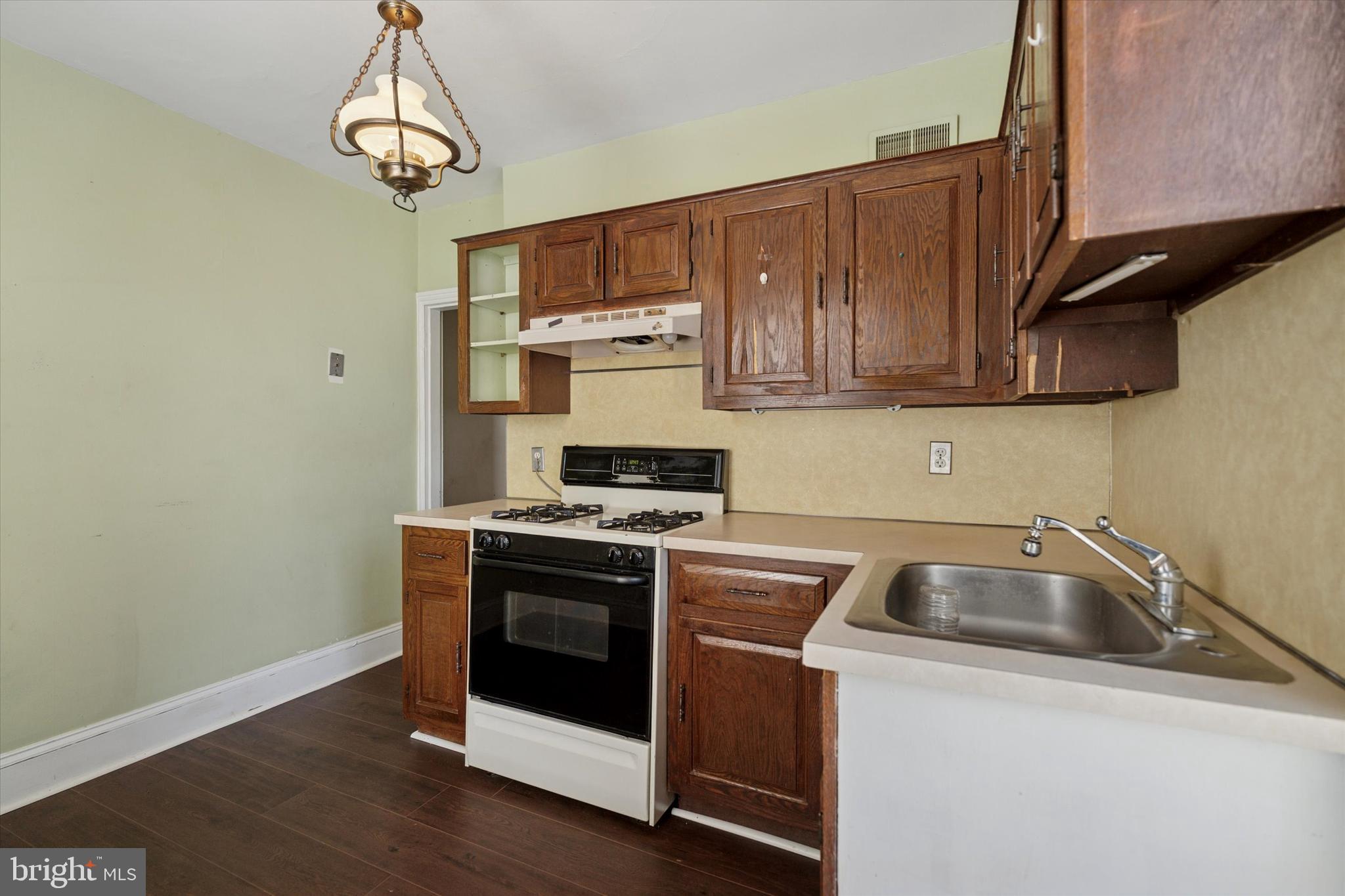 6232 Ridge Avenue Philadelphia, PA 19128 - Photo 12 of 33 a kitchen with stainless steel appliances granite countertop a sink a stove and a refrigerator