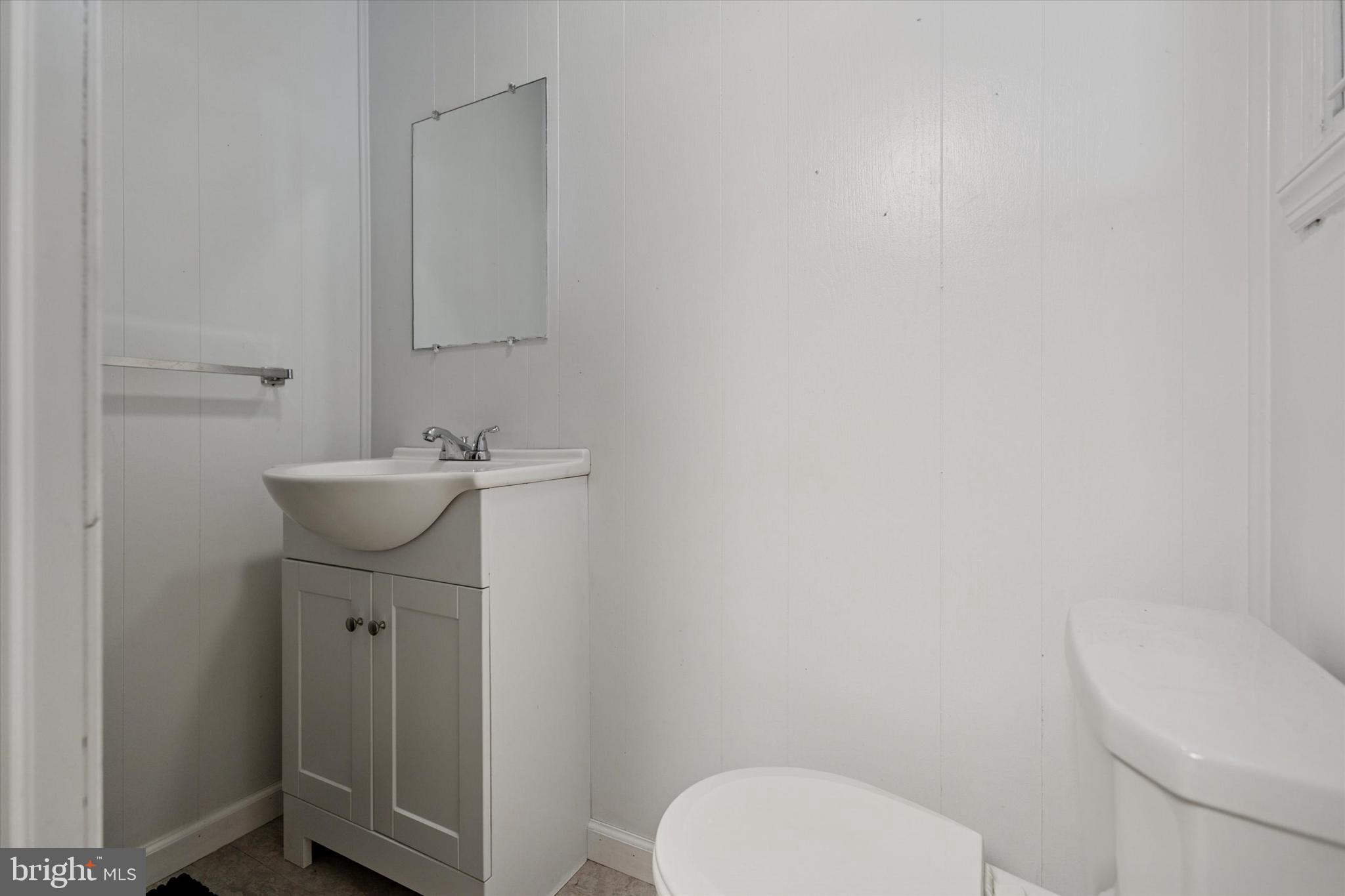 6232 Ridge Avenue Philadelphia, PA 19128 - Photo 27 of 33 a bathroom with a sink a toilet and mirror