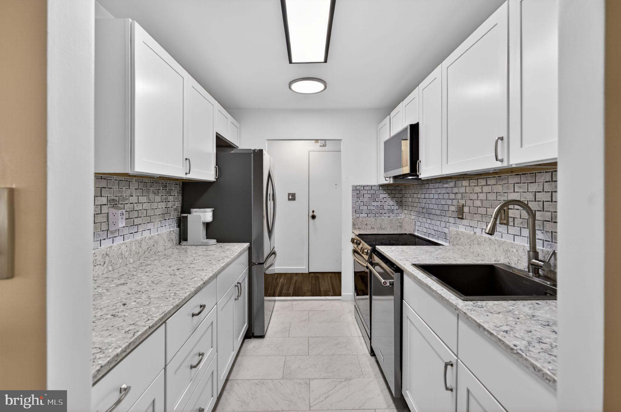 9701 Fields Road, Unit 200 Gaithersburg, MD 20878 - Photo 18 of 31 a kitchen with stainless steel appliances granite countertop a sink stove and refrigerator