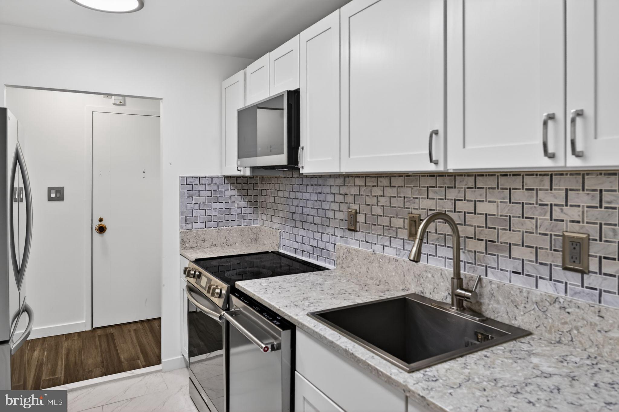 9701 Fields Road, Unit 200 Gaithersburg, MD 20878 - Photo 19 of 31 a kitchen with a sink and a refrigerator