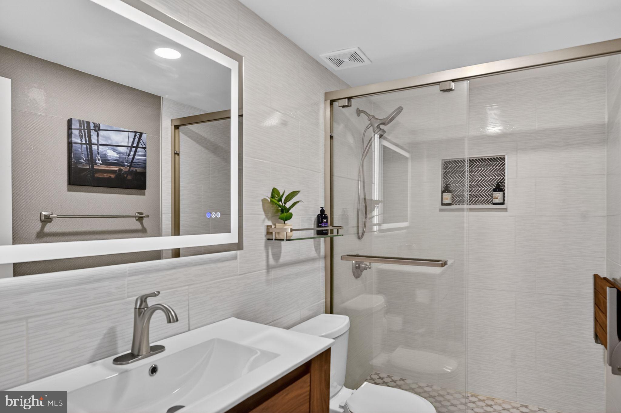 9701 Fields Road, Unit 200 Gaithersburg, MD 20878 - Photo 23 of 31 a bathroom with a sink and a mirror