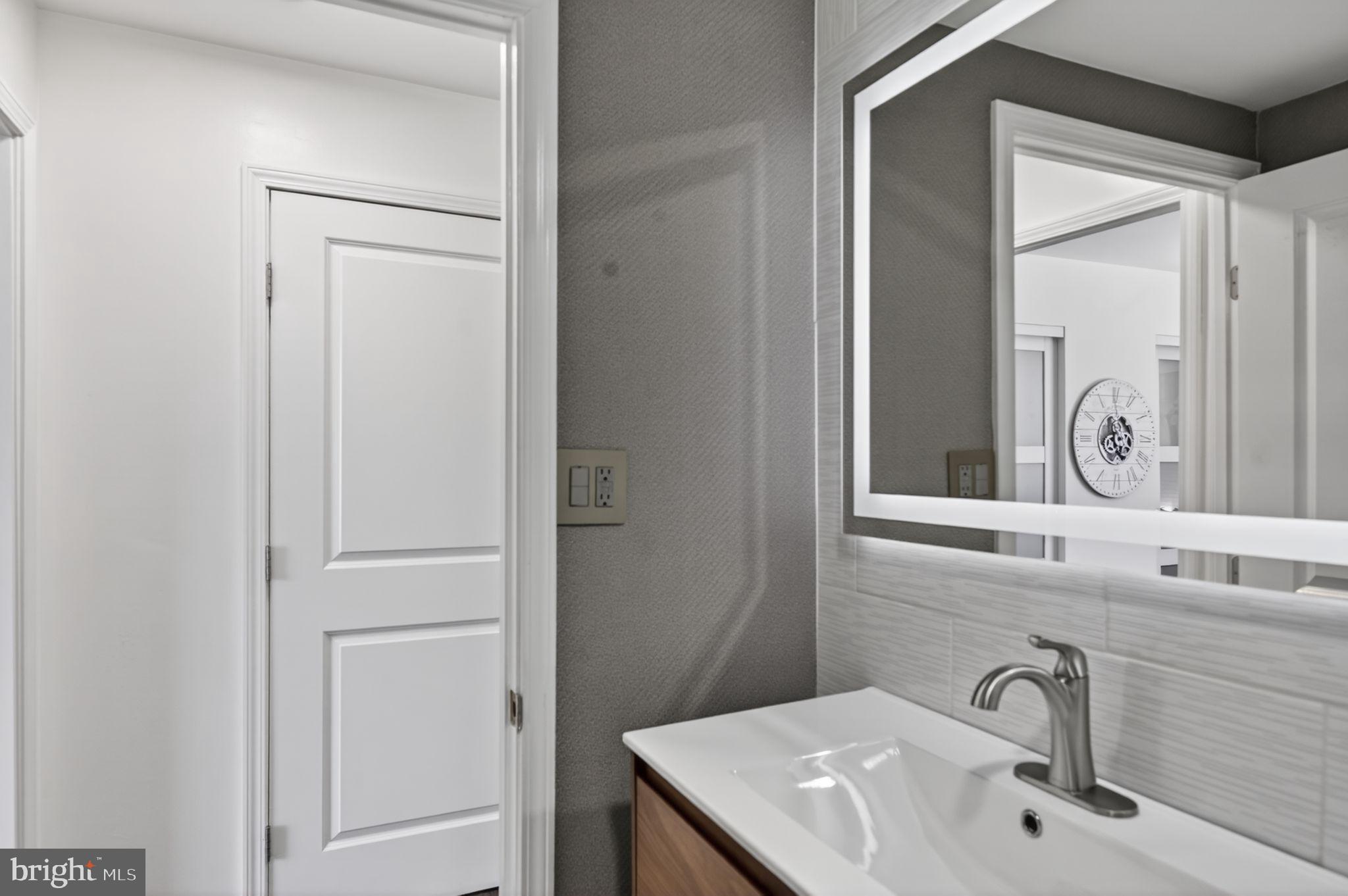 9701 Fields Road, Unit 200 Gaithersburg, MD 20878 - Photo 24 of 31 a bathroom with a sink and a mirror