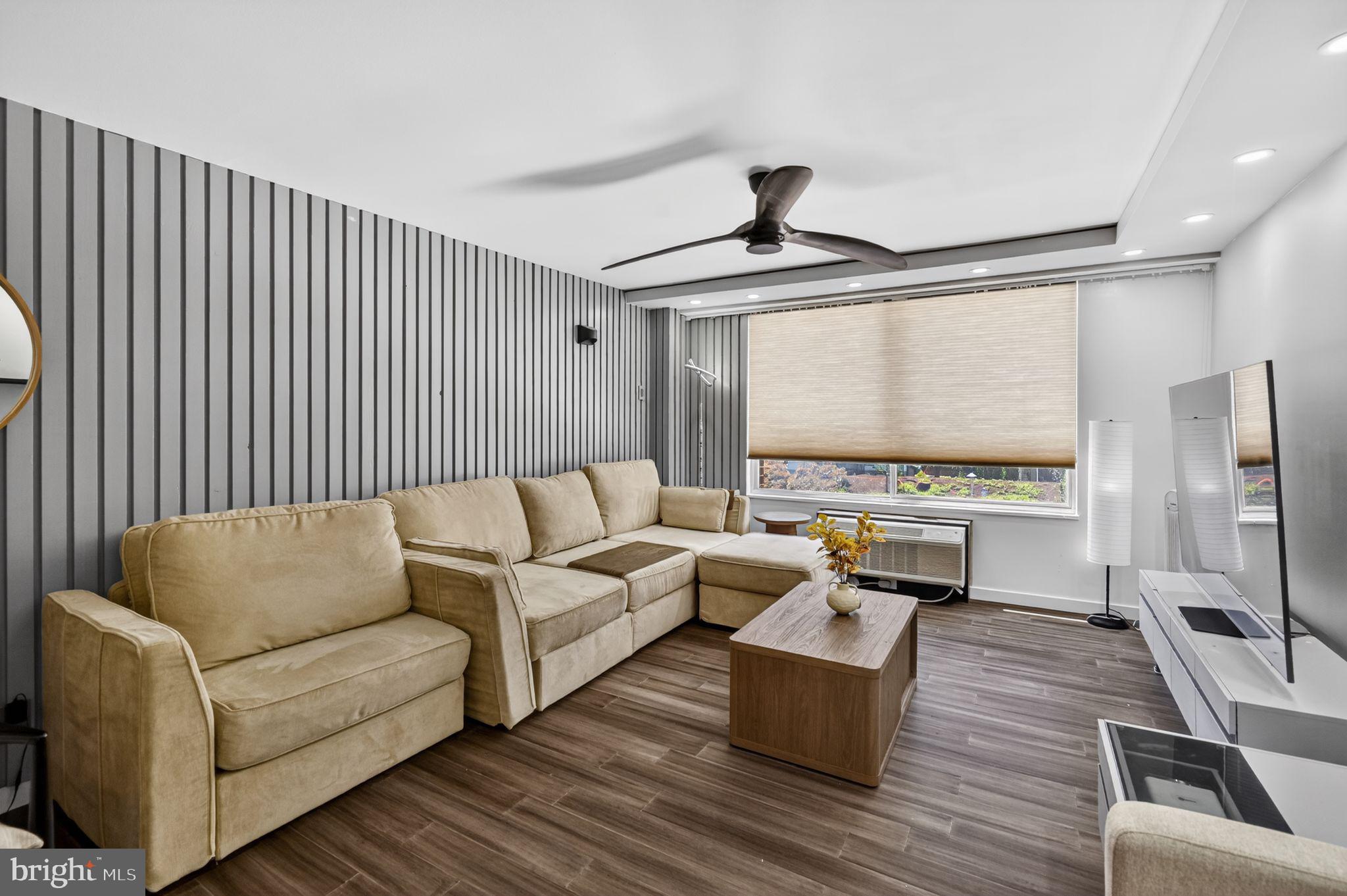 9701 Fields Road, Unit 200 Gaithersburg, MD 20878 - Photo 7 of 31 a living room with furniture and a flat screen tv