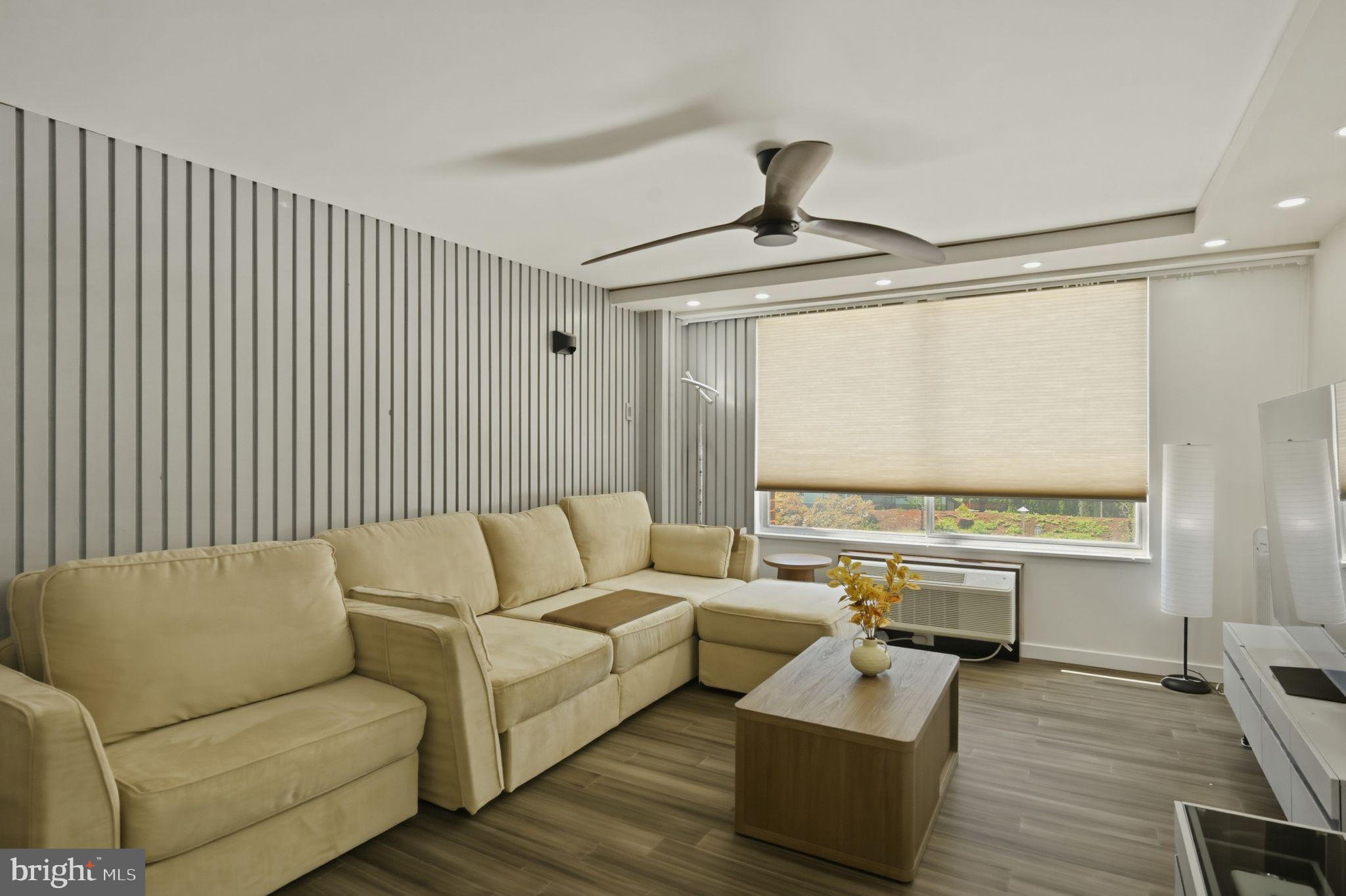 9701 Fields Road, Unit 200 Gaithersburg, MD 20878 - Photo 10 of 31 a living room with furniture and a large window