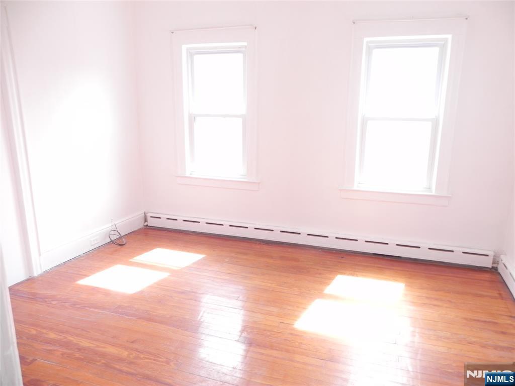 33 Center Street, Unit 1 Little Ferry, NJ 07643 - Photo 3 of 12 a view of a room with wooden floor and a window