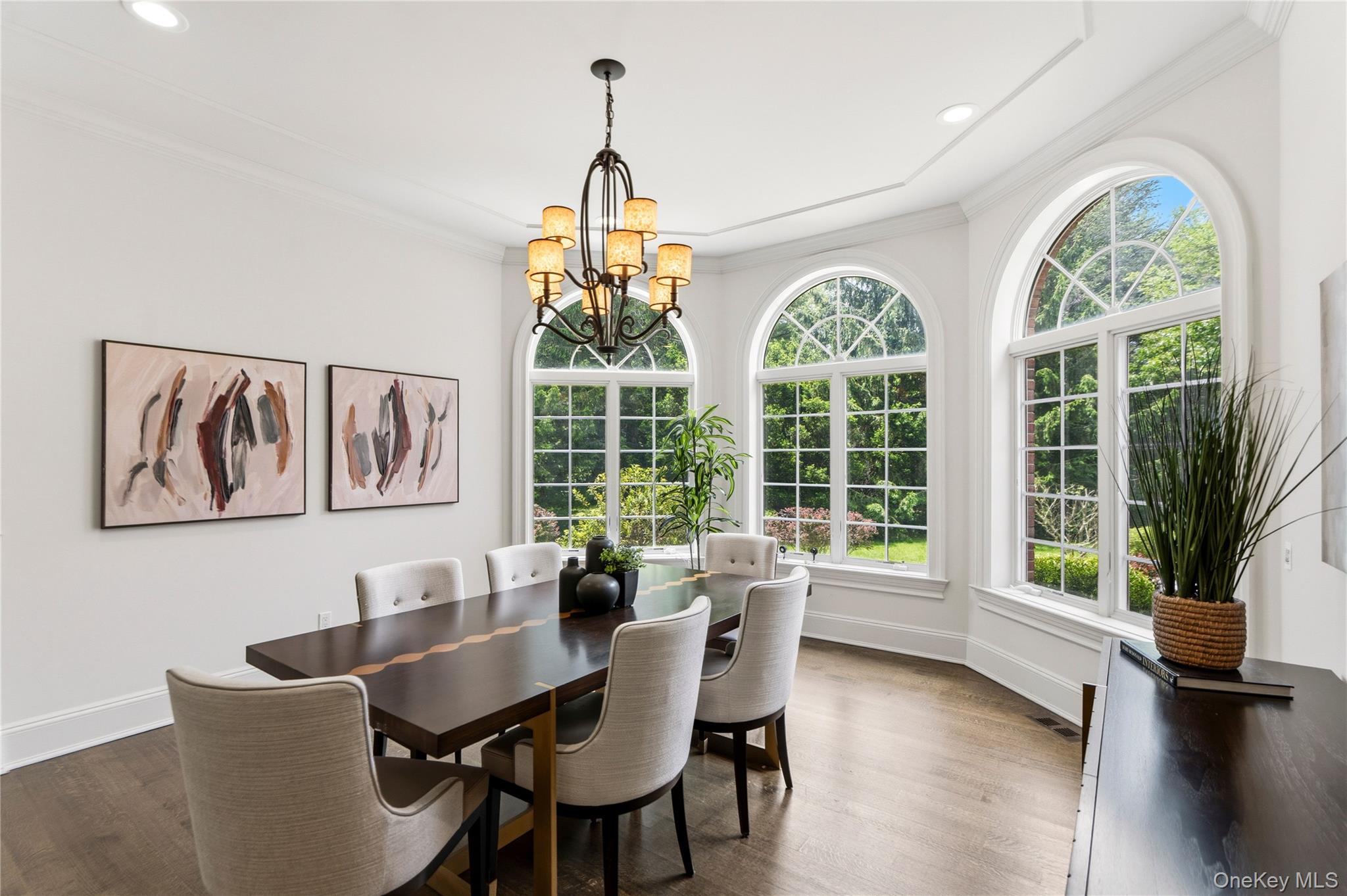 1960 Midlane Road South Syosset, NY 11791 - Photo 11 of 46 a dining room with furniture a chandelier and wooden floor