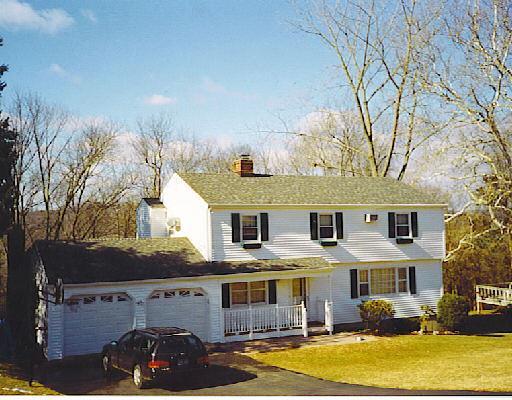 a view of house with outdoor space and swimming pool