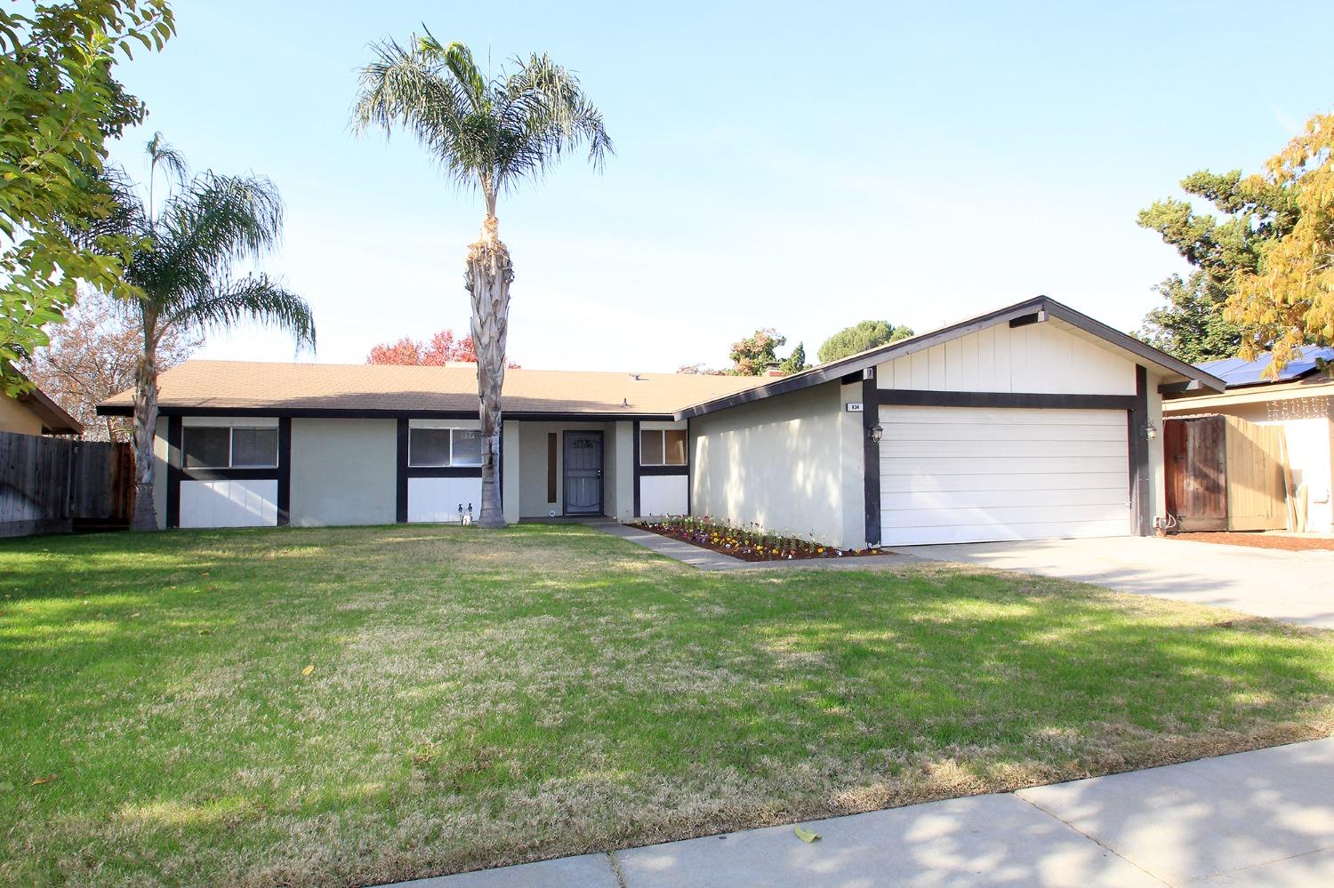 a front view of house with yard and trees