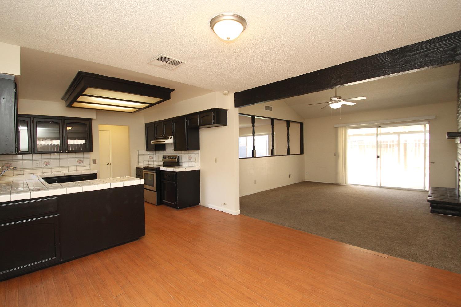 834 Fordham Avenue Clovis, CA 93611 - Photo 11 of 26 a kitchen with stainless steel appliances granite countertop a sink and cabinets