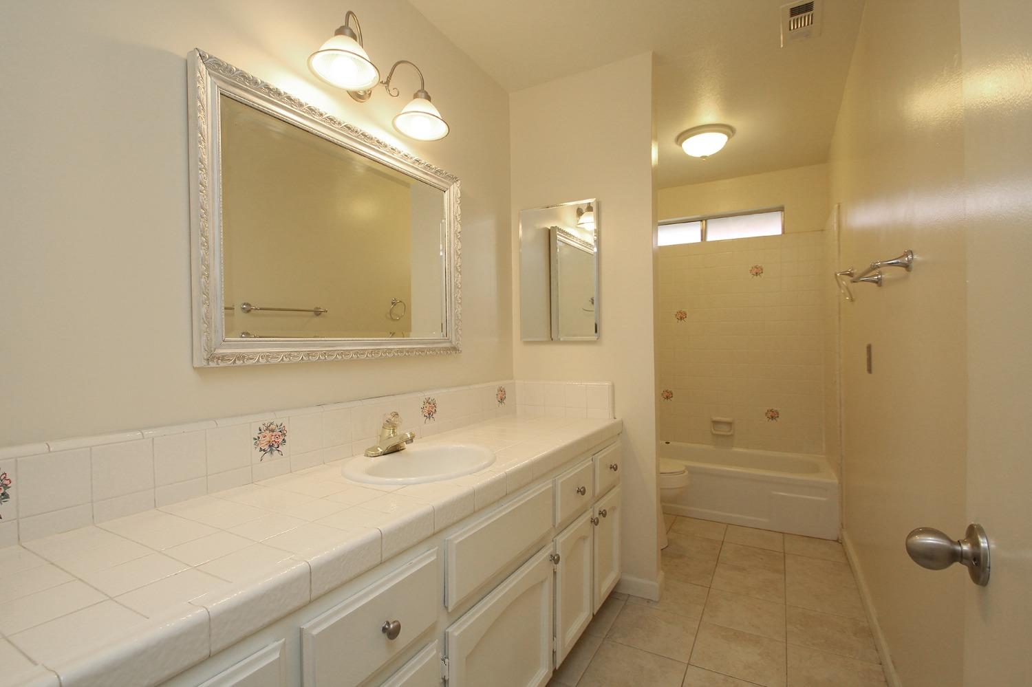 834 Fordham Avenue Clovis, CA 93611 - Photo 19 of 26 a bathroom with a double vanity sink mirror and shower
