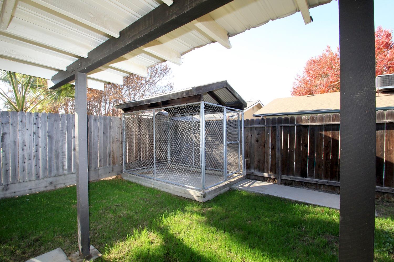 834 Fordham Avenue Clovis, CA 93611 - Photo 26 of 26 a view of a backyard with a small cabin and a chair