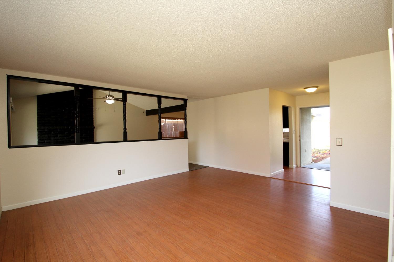 834 Fordham Avenue Clovis, CA 93611 - Photo 7 of 26 a view of an empty room with wooden floor