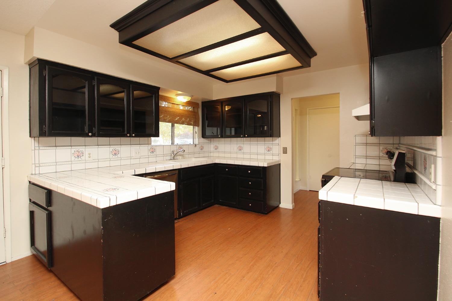 834 Fordham Avenue Clovis, CA 93611 - Photo 8 of 26 a kitchen with a sink stove top oven and cabinets