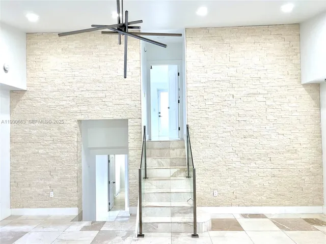 a kitchen with stainless steel appliances a sink and a large window