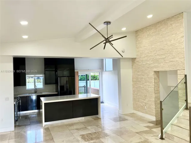 a kitchen with a refrigerator and a sink