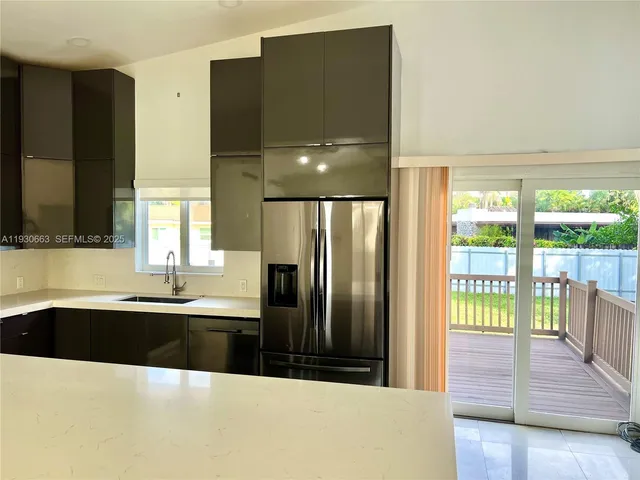 a kitchen with granite countertop a stove a microwave a sink and cabinets