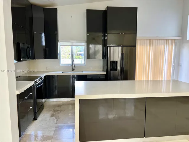 a kitchen with a sink and a microwave