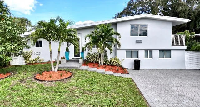a front view of house with yard and swimming pool