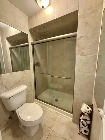 a bathroom with a toilet and a shower