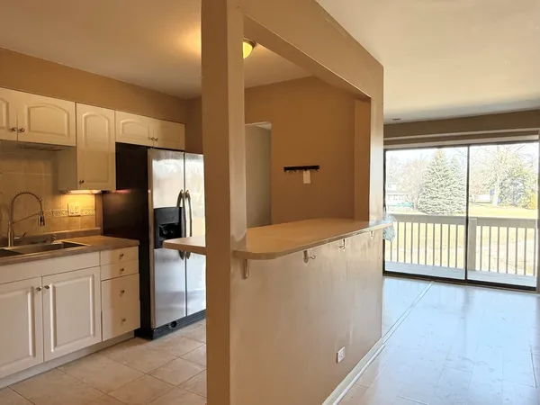 a kitchen with stainless steel appliances a refrigerator sink and cabinets