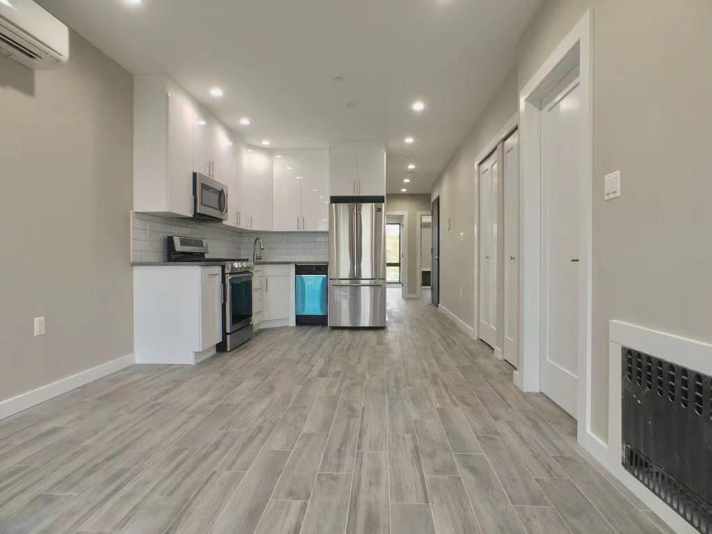621 48th Street Brooklyn, NY 11220 - Photo 5 of 14 a kitchen with stainless steel appliances granite countertop a refrigerator and a stove top oven