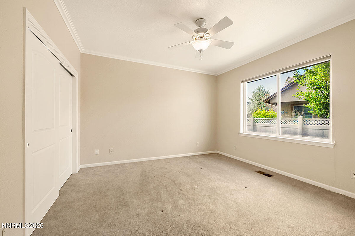 402 Chianti Way Dayton, NV 89403 - Photo 19 of 29 an empty room with windows and fan