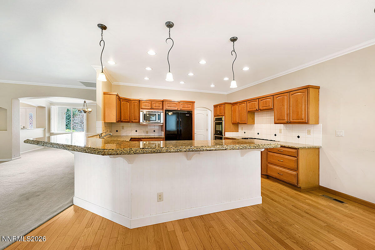 402 Chianti Way Dayton, NV 89403 - Photo 8 of 29 a large kitchen with stainless steel appliances granite countertop a sink a stove and a wooden floors