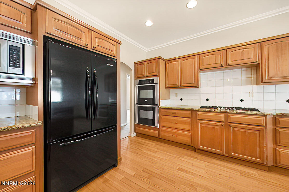 402 Chianti Way Dayton, NV 89403 - Photo 9 of 29 a kitchen with stainless steel appliances a refrigerator sink and cabinets