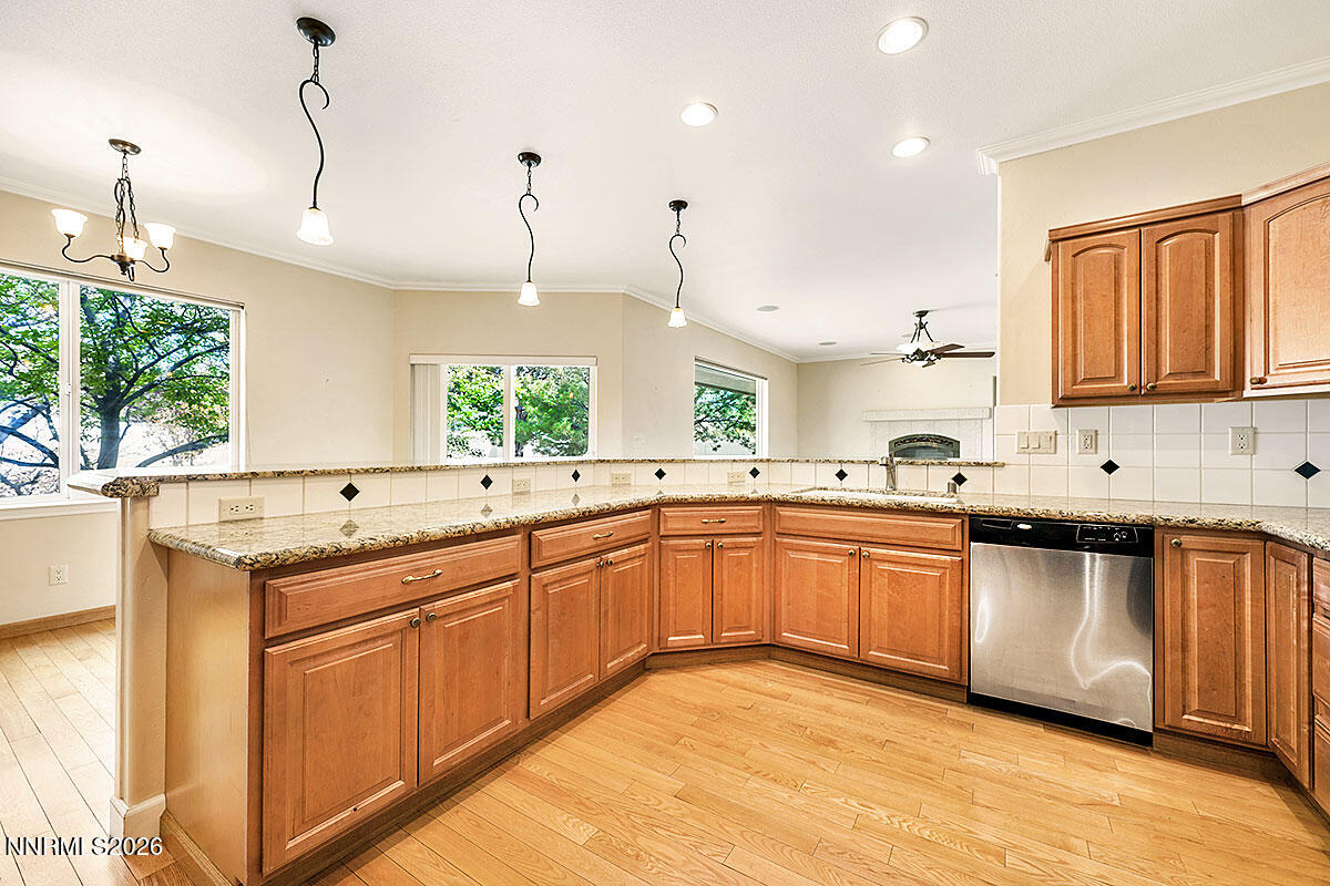 402 Chianti Way Dayton, NV 89403 - Photo 10 of 29 a large kitchen with a sink window and cabinets