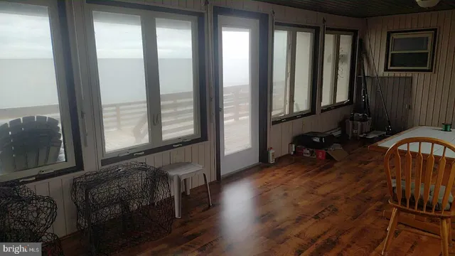 a view of hallway with furniture and a window