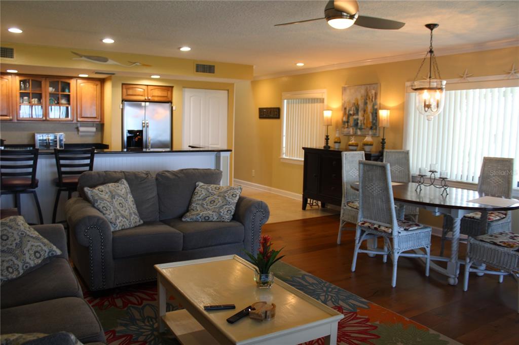 335 Windrush Loop, Unit 335 Tarpon Springs, FL 34689 - Photo 4 of 18 a living room with furniture and wooden floor