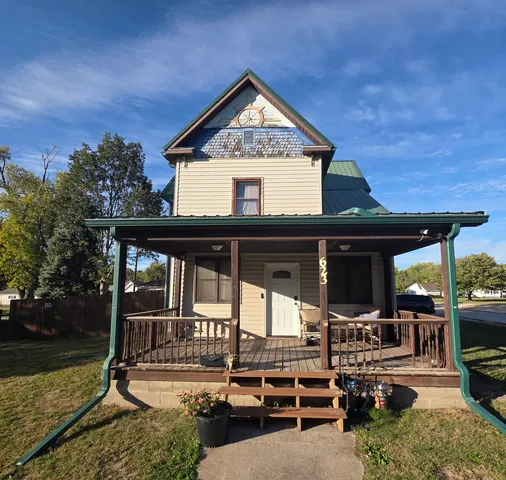 a view of a house with backyard porch and sitting area
