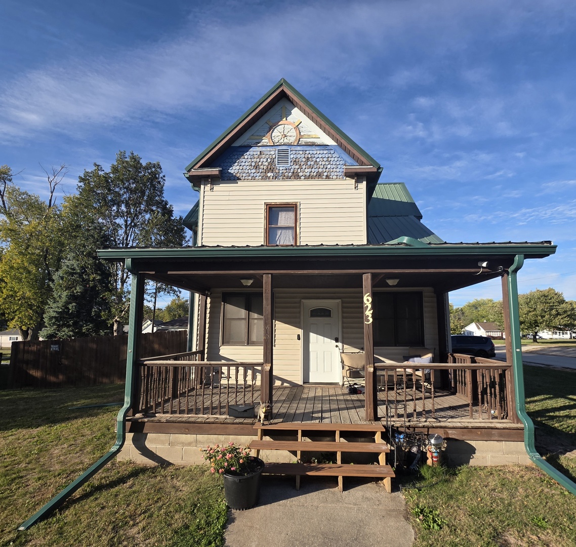 a view of a house with backyard porch and sitting area