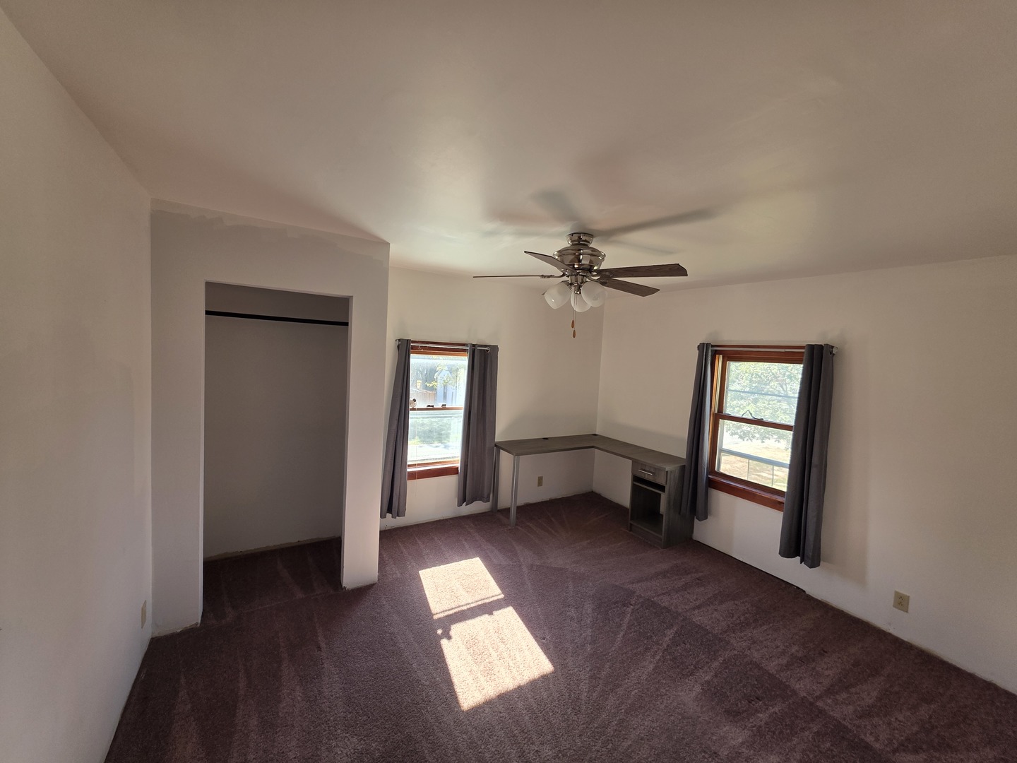 623 East Clay Street Clinton, IL 61727 - Photo 12 of 14 a view of empty room with windows and ceiling fan
